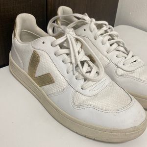 White sneakers with gold accents.